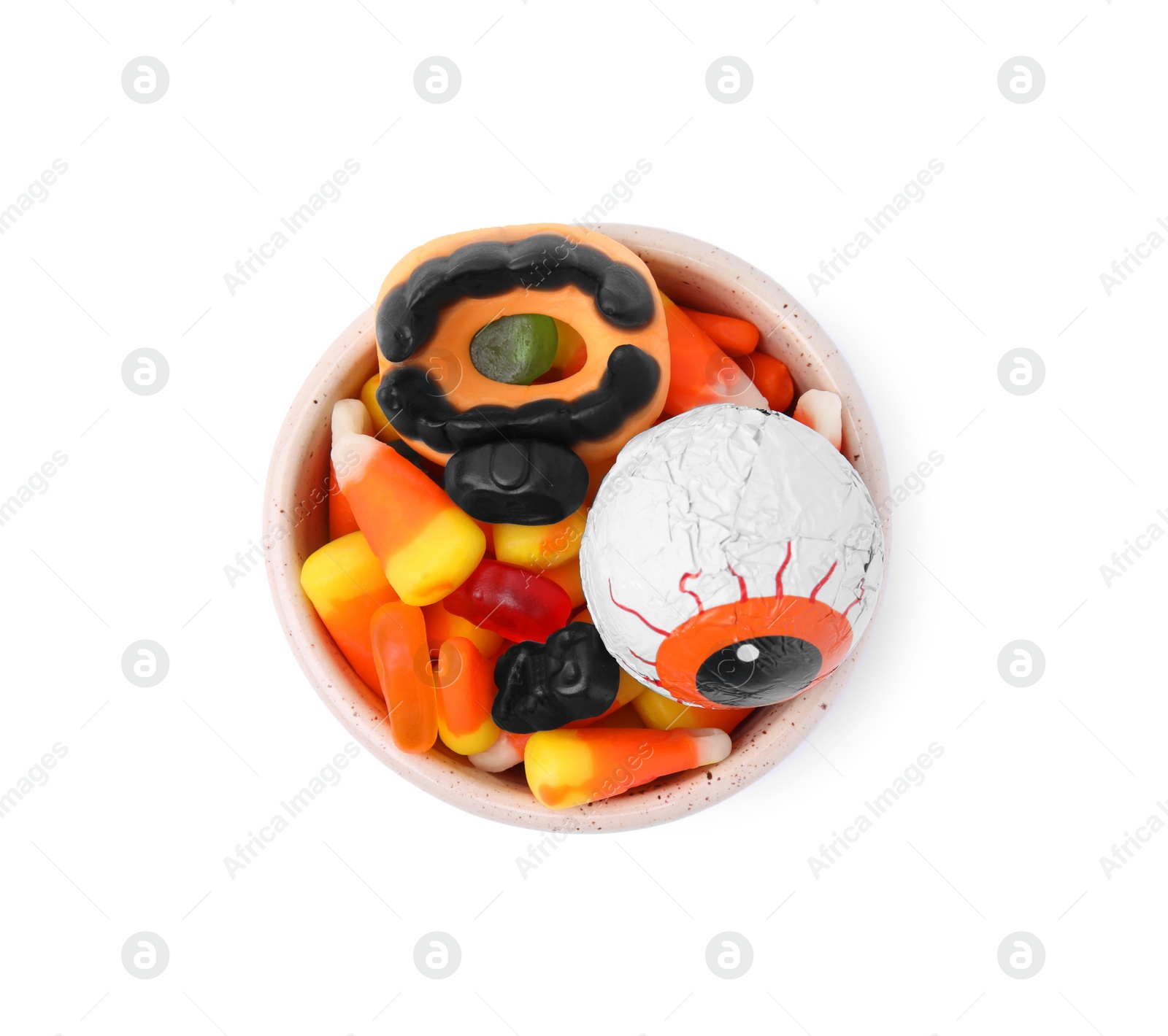 Photo of Bowl of delicious colorful candies isolated on white, top view. Halloween sweets