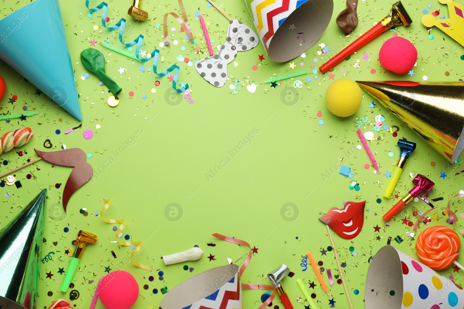 Photo of Frame of festive items on light green background, flat lay with space for text. Surprise party concept