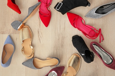 Photo of Different female shoes on floor, top view