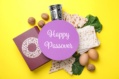 Image of Symbolic Passover items and card on yellow background, flat lay. Pesah celebration