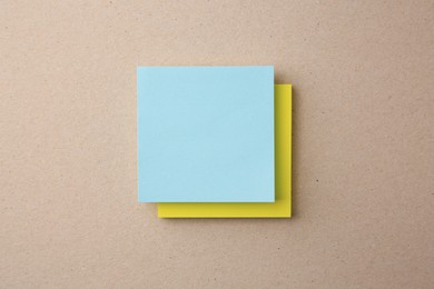 Blank paper notes on beige background, top view