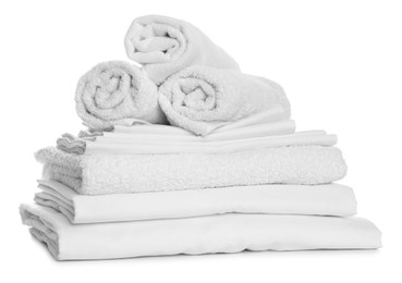 Photo of Stack of towels and bed sheets on white background