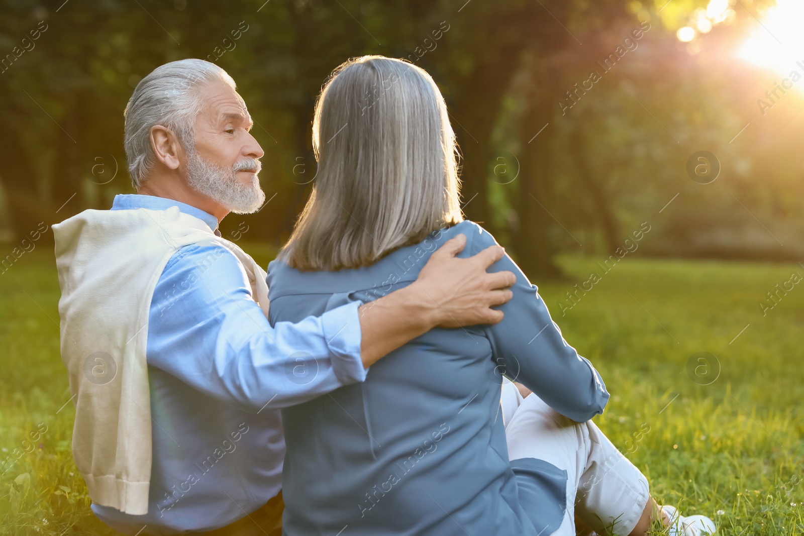 Photo of Affectionate senior couple spending time together in park. Romantic date