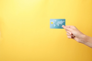 Photo of Woman holding credit card on color background