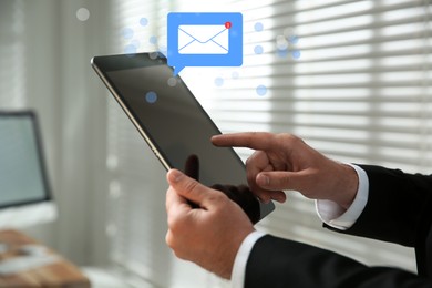 Image of Email. Man using tablet indoors, closeup. Incoming letter notification over device