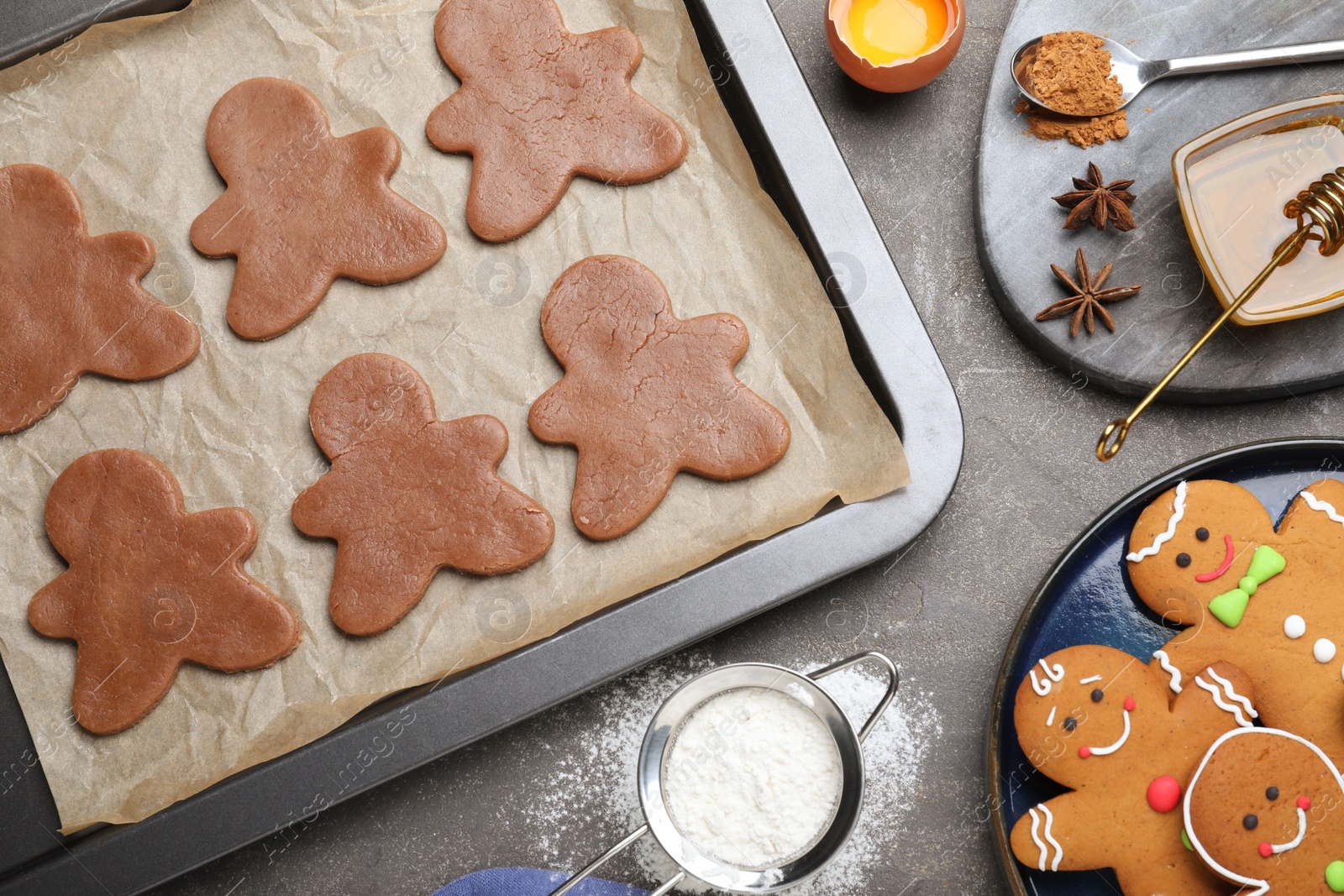 Photo of Flat lay composition with homemade gingerbread man cookies on black table