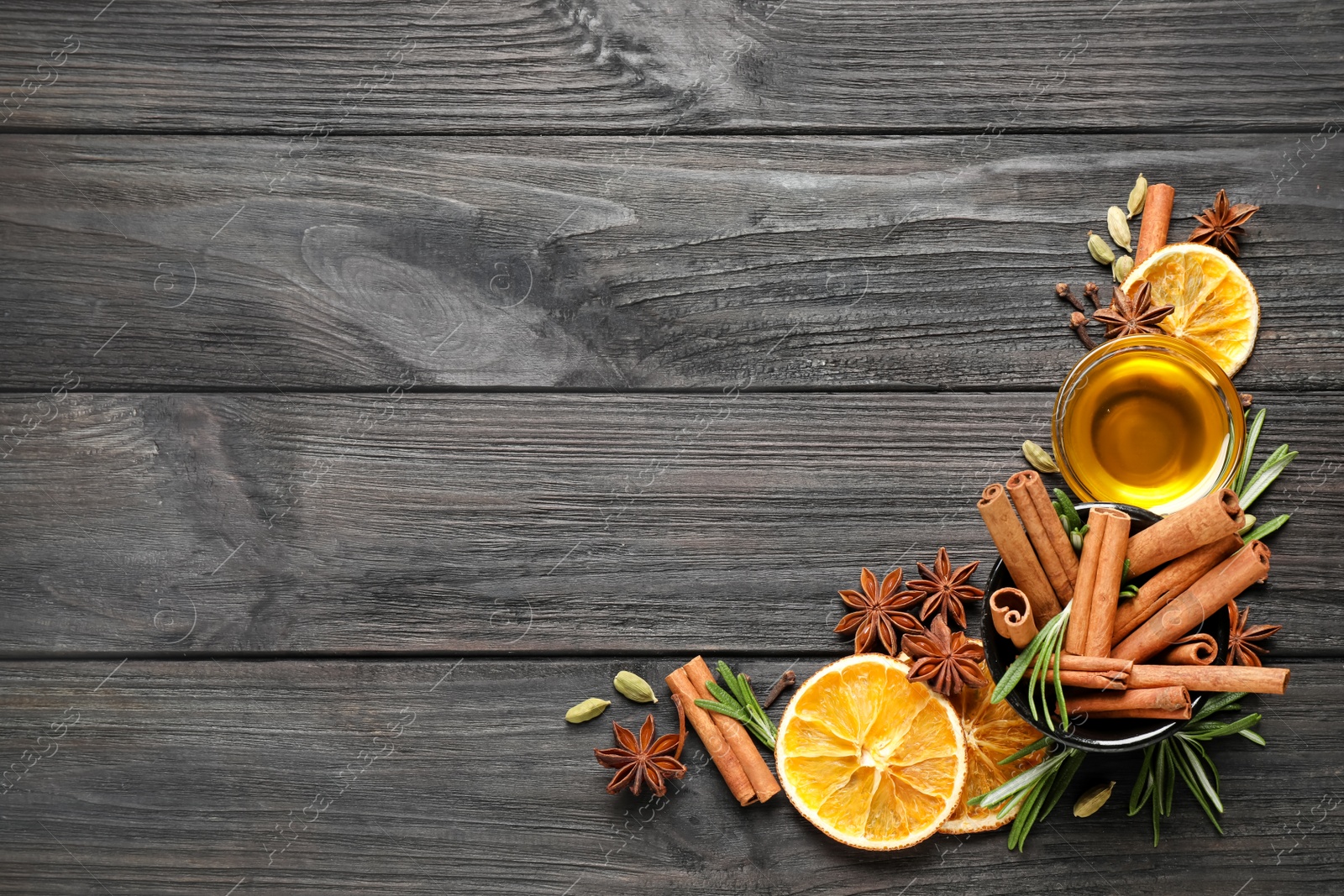 Photo of Flat lay composition with mulled wine ingredients on black wooden table. Space for text