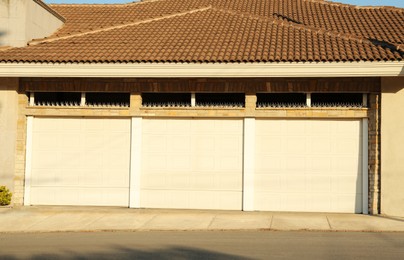 Garage building with closed white sectional gates