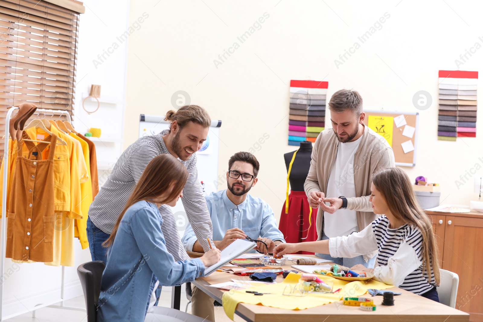 Photo of Fashion designers creating new clothes in studio