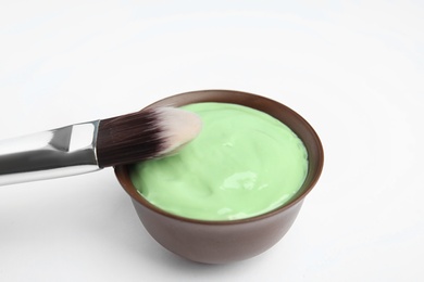 Professional face mask with brush on white background