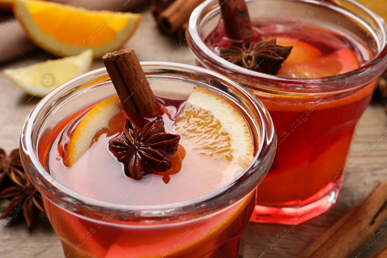 Photo of Glasses with aromatic punch drink on table, closeup view