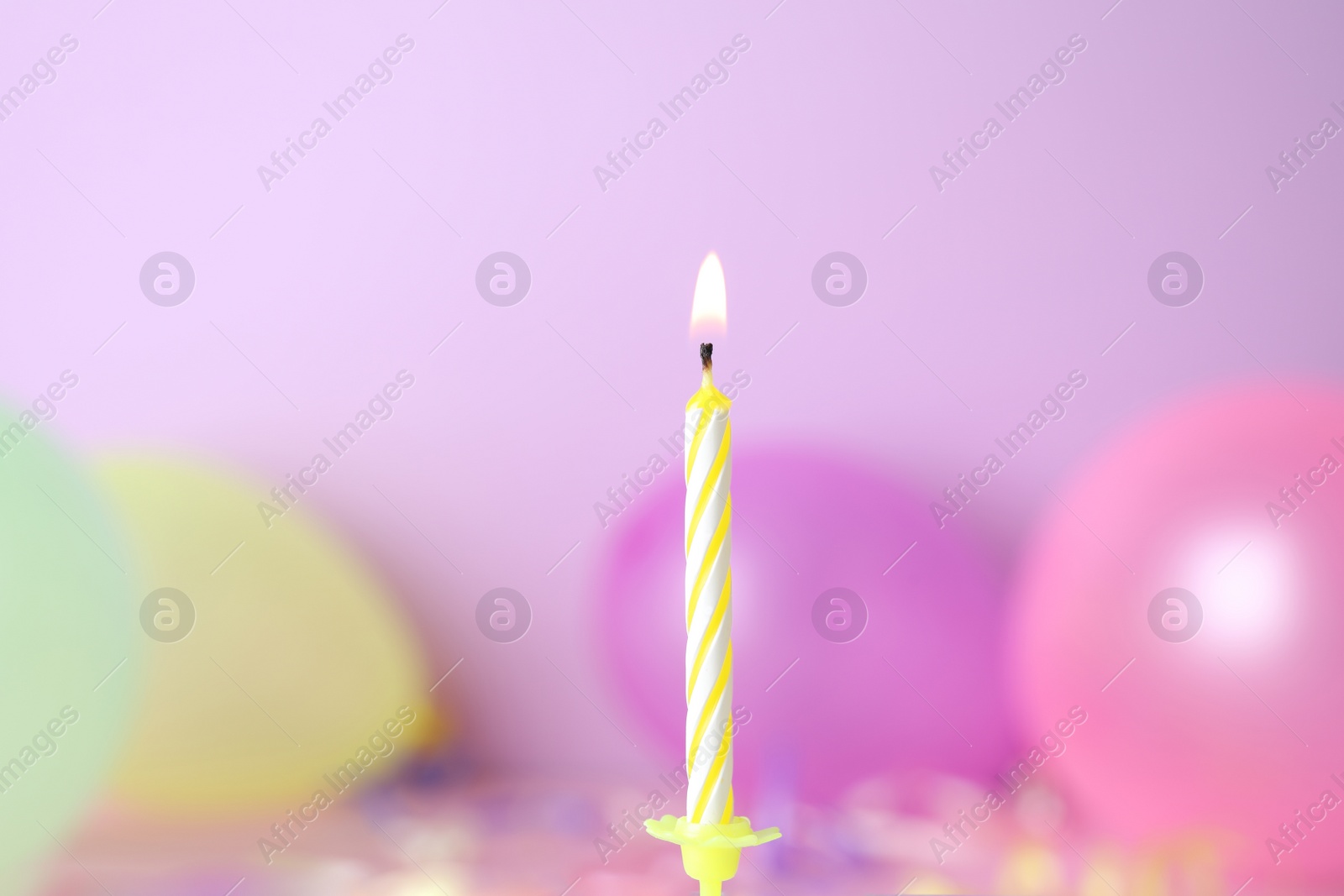 Photo of Burning birthday cake candle on color background. Space for text