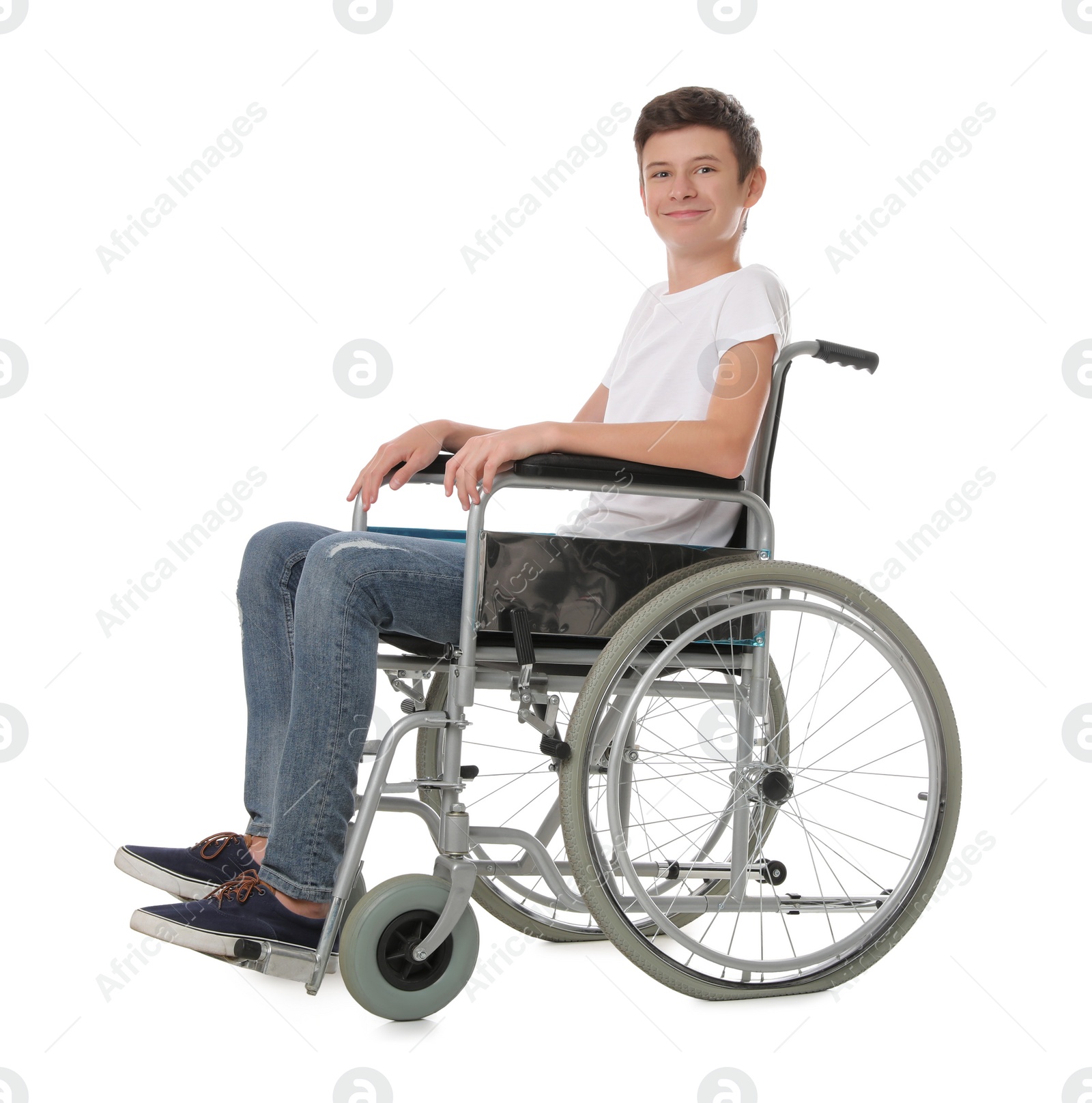 Photo of Teen boy in wheelchair on white background