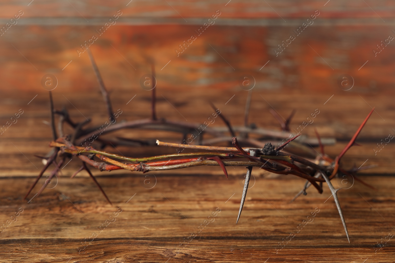 Photo of Crown of thorns on wooden table, space for text. Easter attribute