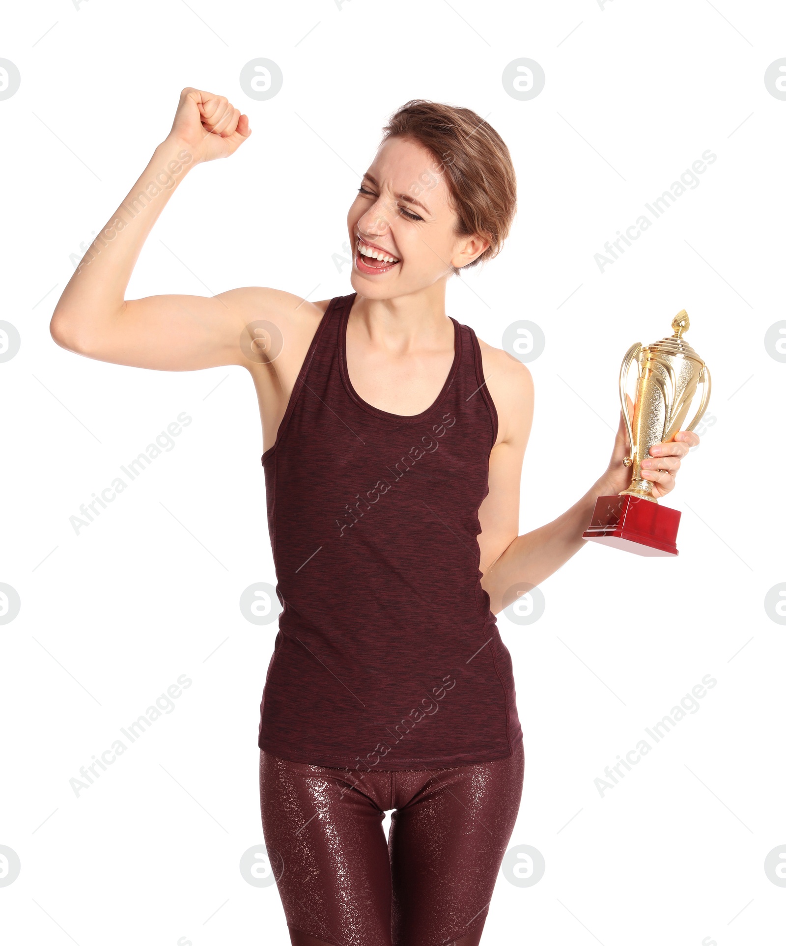 Photo of Portrait of happy young sportswoman with gold trophy cup on white background