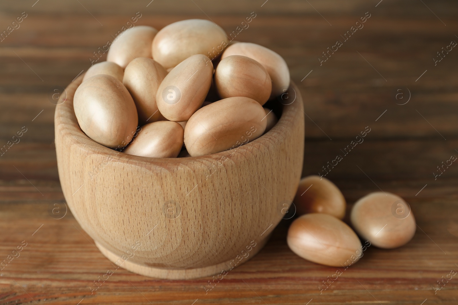 Photo of Raw jackfruit seeds in bowl on wooden table