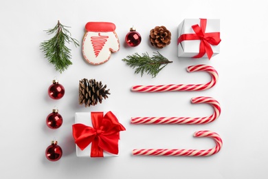 Photo of Flat lay composition with candy canes and Christmas decor on white background
