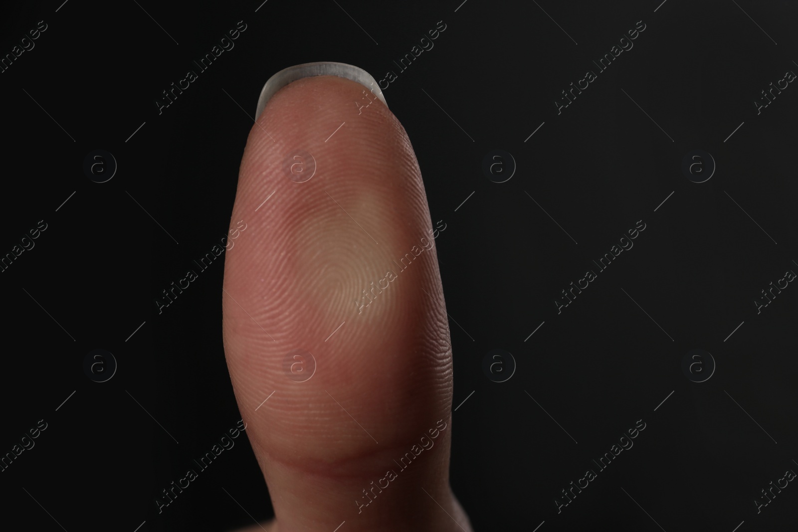 Photo of Woman pressing control glass of biometric fingerprint scanner on dark background, closeup. Space for text