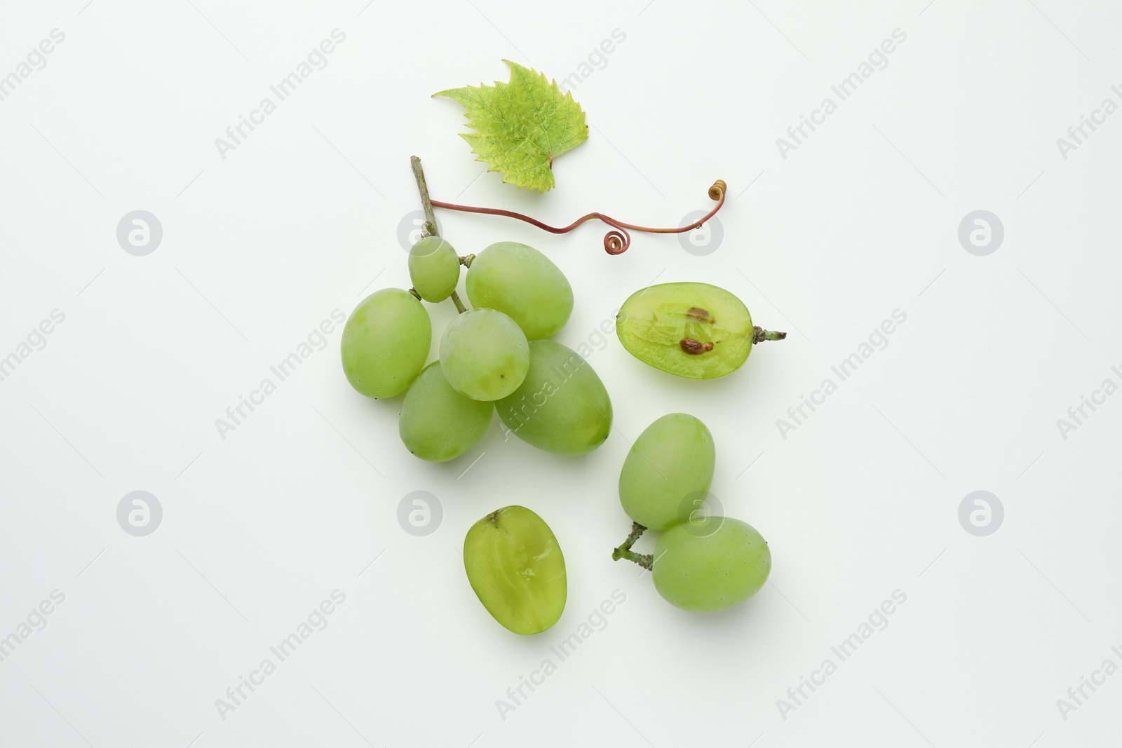 Photo of Fresh grapes and leaf on white background, top view