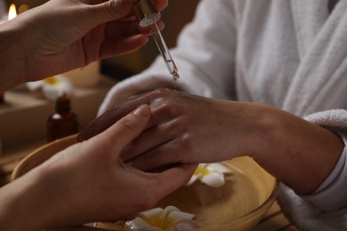 Photo of Woman receiving hand treatment in spa, closeup