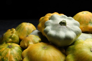 Fresh ripe pattypan squashes on dark background, closeup