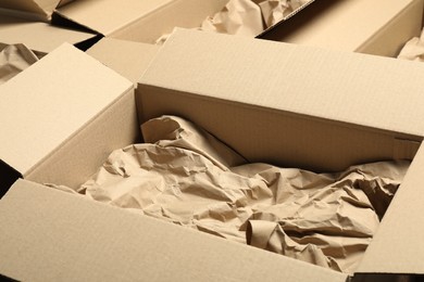 Open cardboard boxes with crumpled paper. Packaging goods