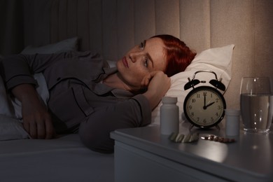Photo of Woman suffering from insomnia in bed at home