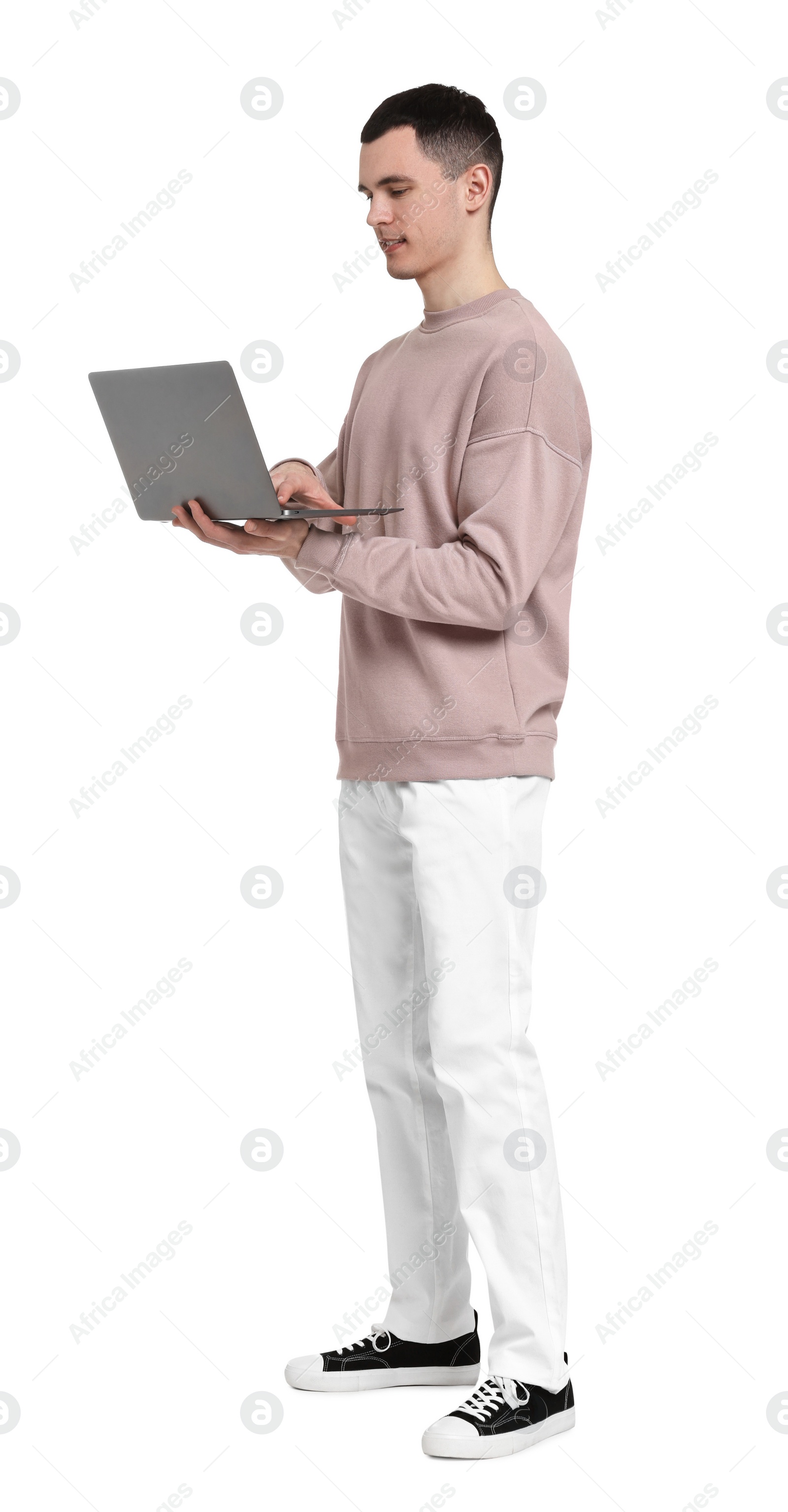 Photo of Handsome young man with laptop on white background