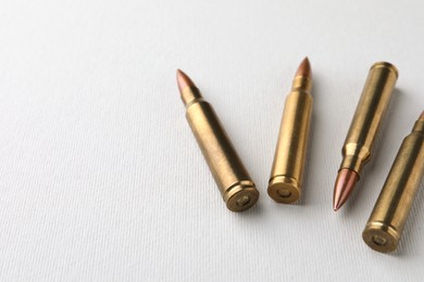 Photo of Bullets on white background, closeup. Space for text