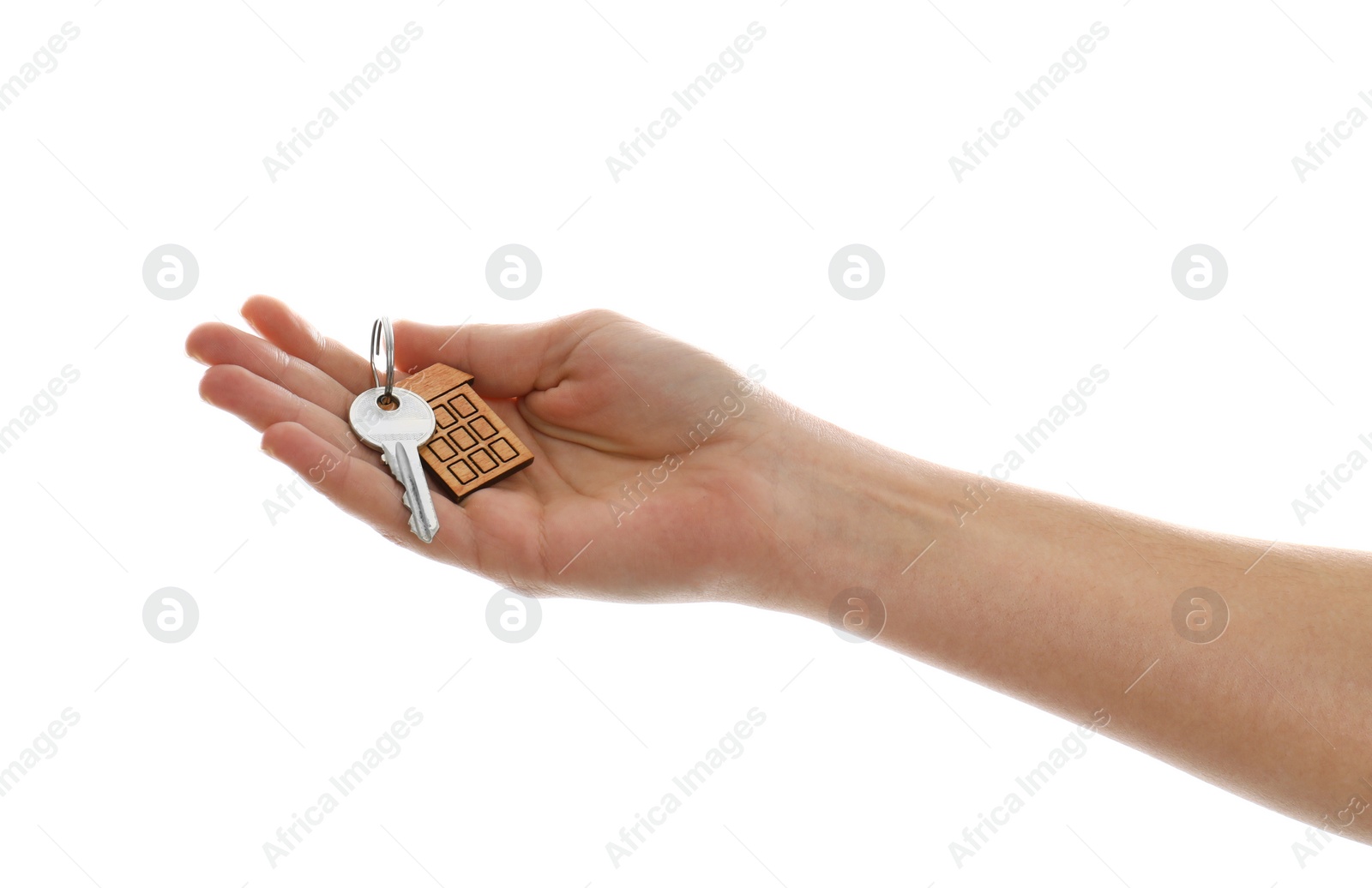 Photo of Real estate agent holding house key with trinket on white background, closeup