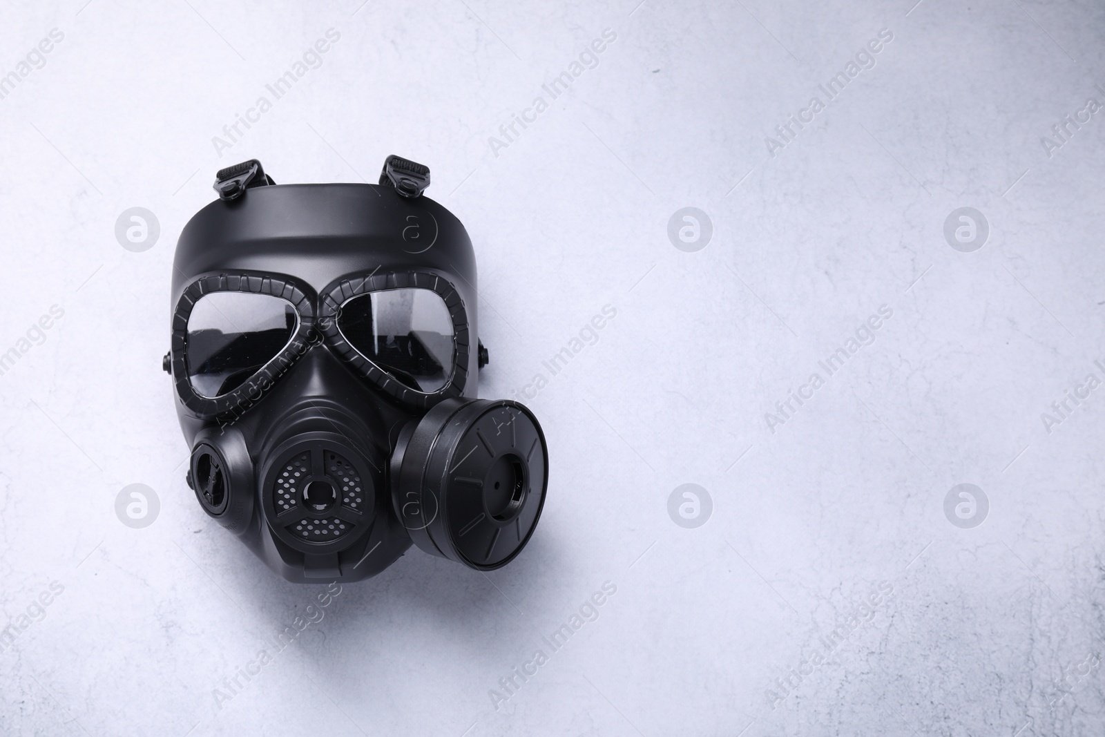 Photo of One gas mask on light grey background, top view. Space for text