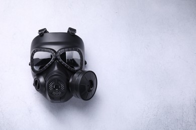 One gas mask on light grey background, top view. Space for text