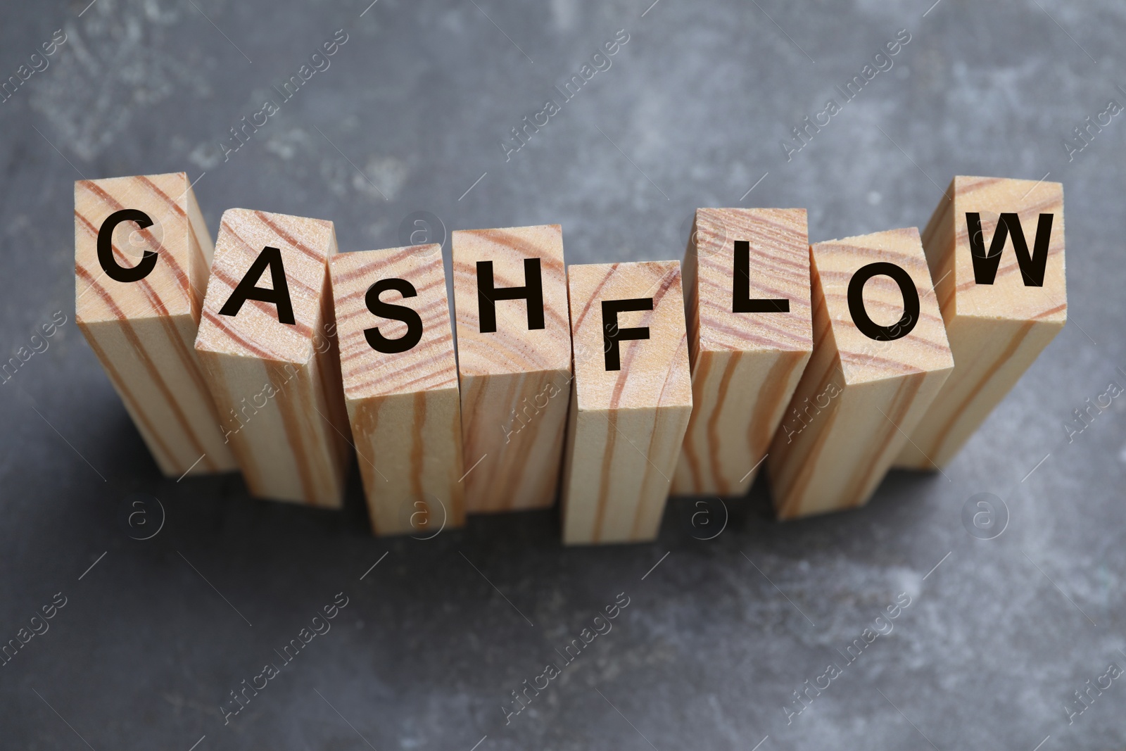 Image of Wooden blocks with phrase Cash FLow on grey background, above view