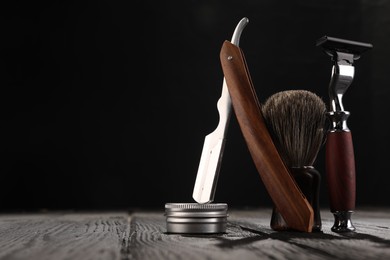 Photo of Moustache and beard styling tools on wooden table. Space for text