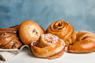 Different delicious fresh pastries on white wooden table