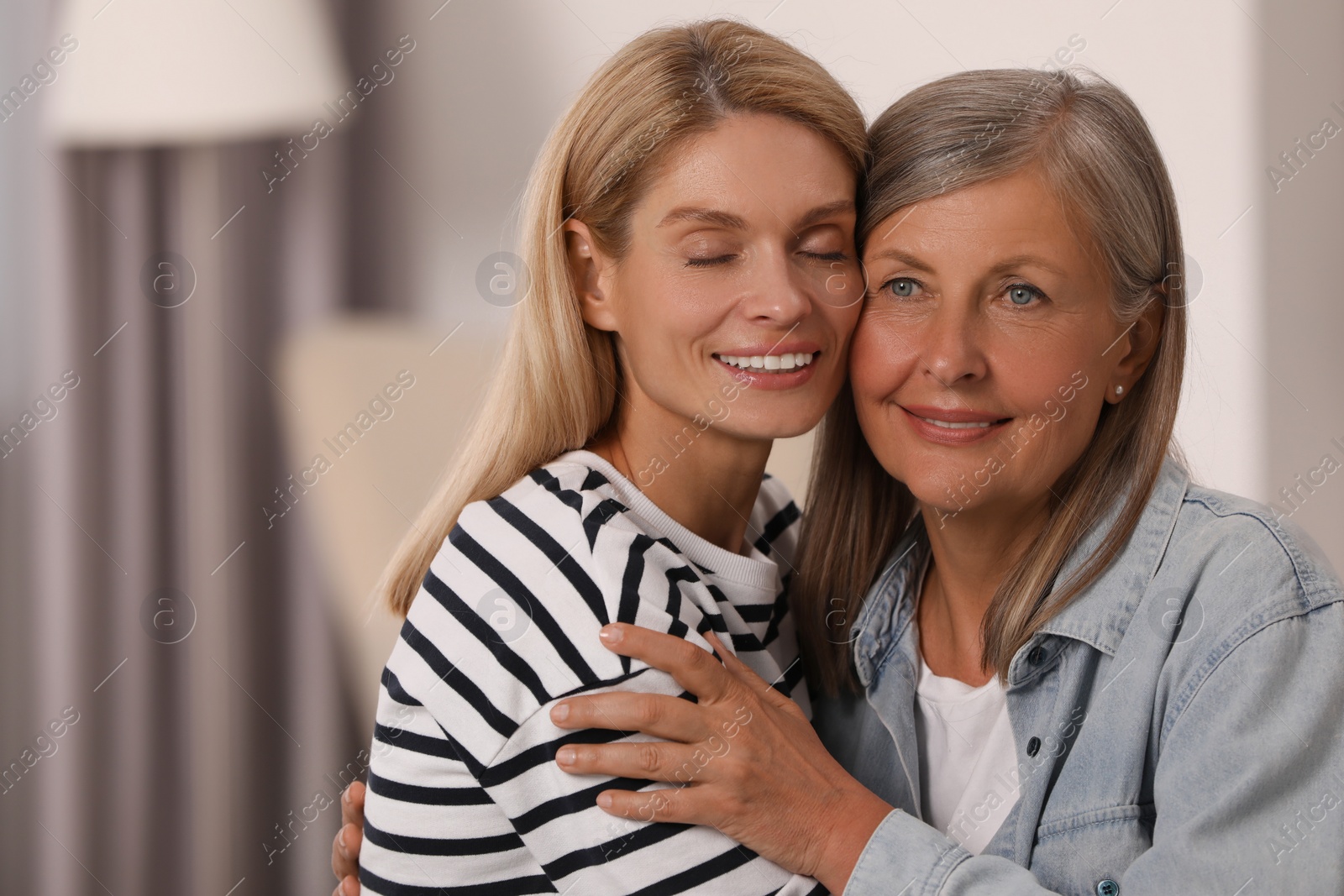 Photo of Happy mature mother and her daughter at home