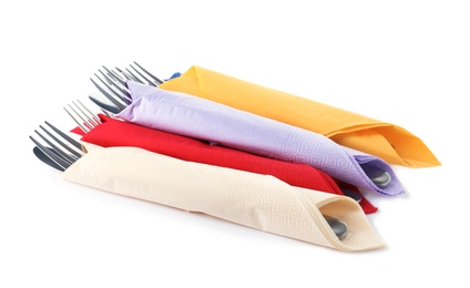 Cutlery wrapped in paper napkins on white background