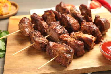 Photo of Skewers with delicious shish kebabs on table, closeup