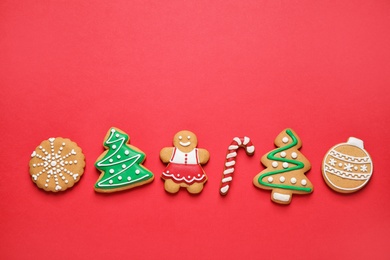 Photo of Flat lay composition with tasty homemade Christmas cookies on red background, space for text