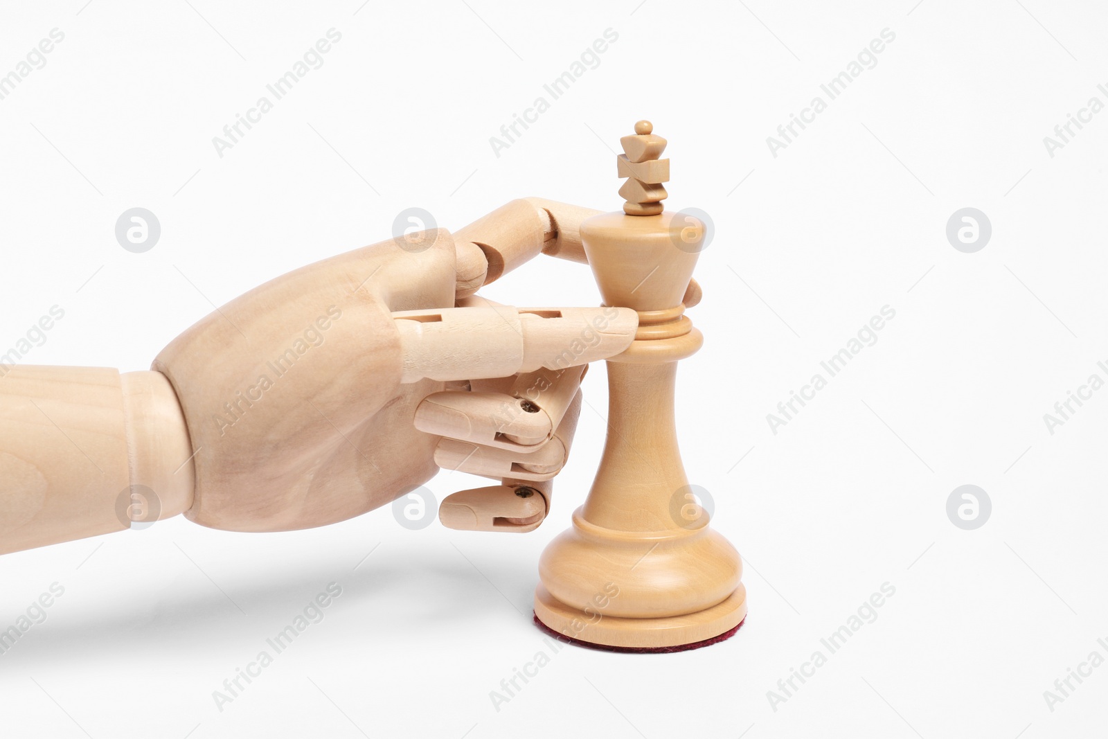 Photo of Robot with chess piece on white background. Wooden hand representing artificial intelligence