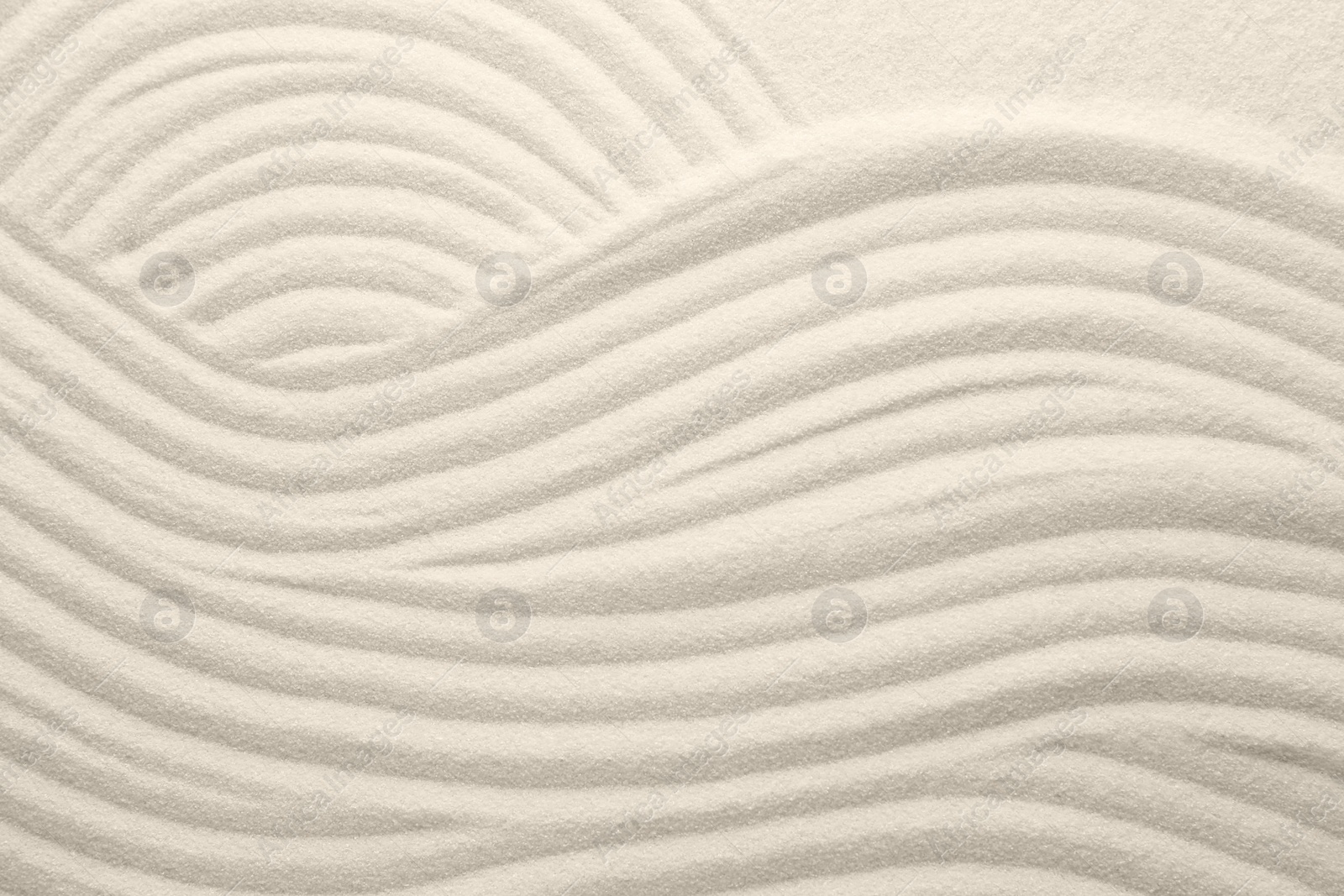 Photo of White sand with pattern as background, top view. Concept of zen and harmony