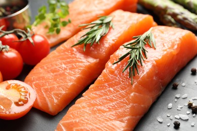 Photo of Fresh raw salmon and ingredients for marinade on grey table, closeup