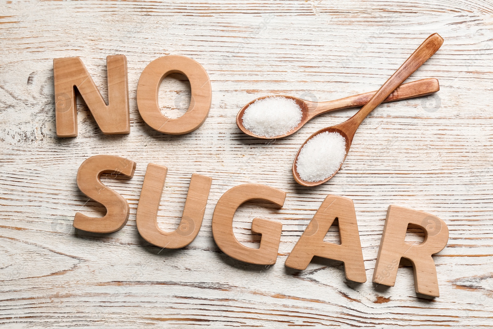 Photo of Flat lay composition with phrase No Sugar on white wooden table