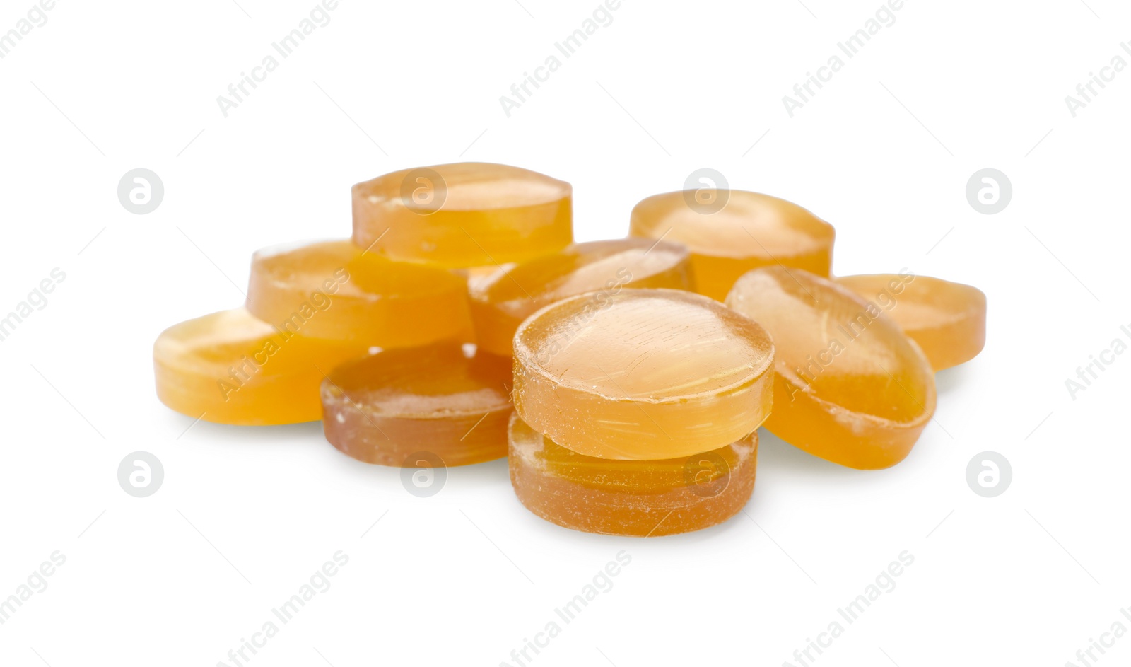 Photo of Many yellow cough drops on white background