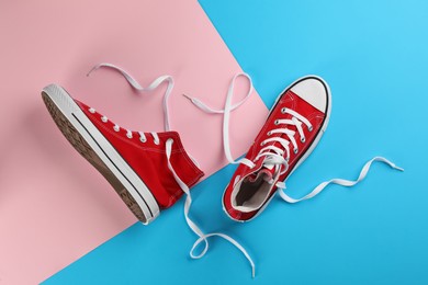 Photo of Pair of trendy sneakers on color background, flat lay