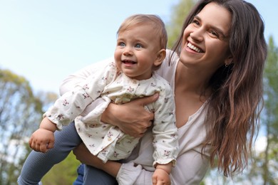 Photo of Happy mother with her cute baby in park on sunny day