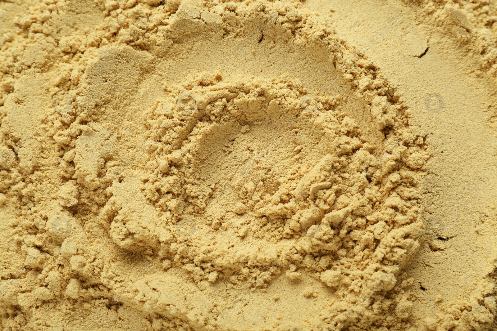 Photo of Aromatic mustard powder as background, top view