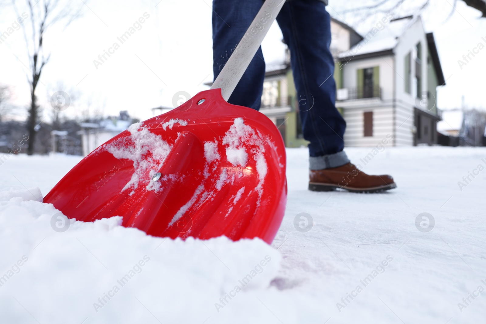 Photo of Man shoveling snow on city street, closeup