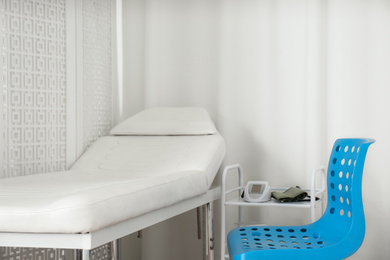 Empty examination couch in modern medical office