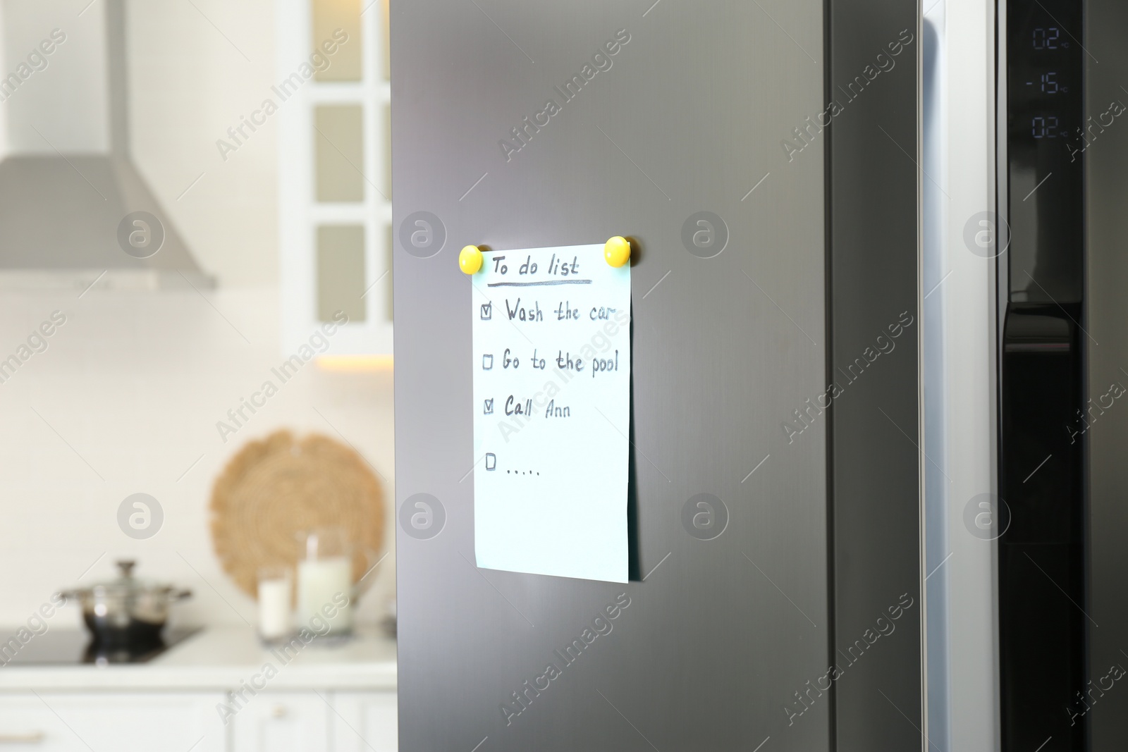 Photo of To do list on fridge in kitchen. Space for text